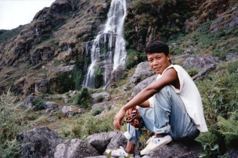 Lalu Limbu, trekking kitchenboy, beneath a waterfall in the Ganesh Himal Region