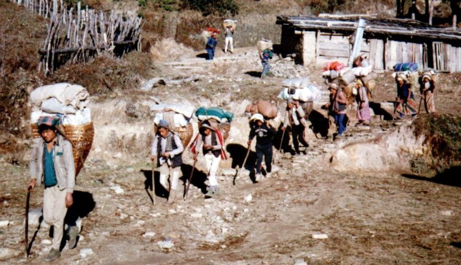 Train of Nepalese porters carrying trade goods on route from Jiri to Namche Bazaar