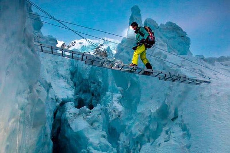 Crossing crevasse in the Khumbu Ice Fall on the South Col Route for Mount Everest