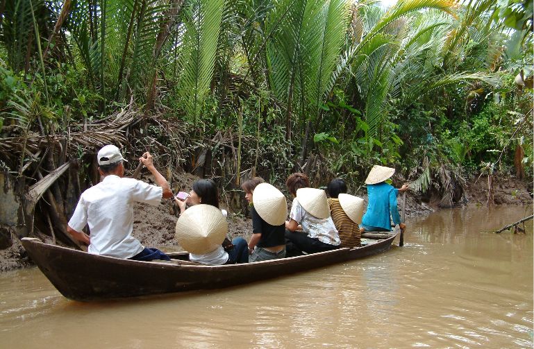 Canoe trip in waterway of Mekong Delta