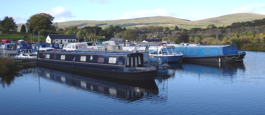 Boats in Auchinstarry Basin on Forth and Clyde Canal beneath the Kilsyth Hills