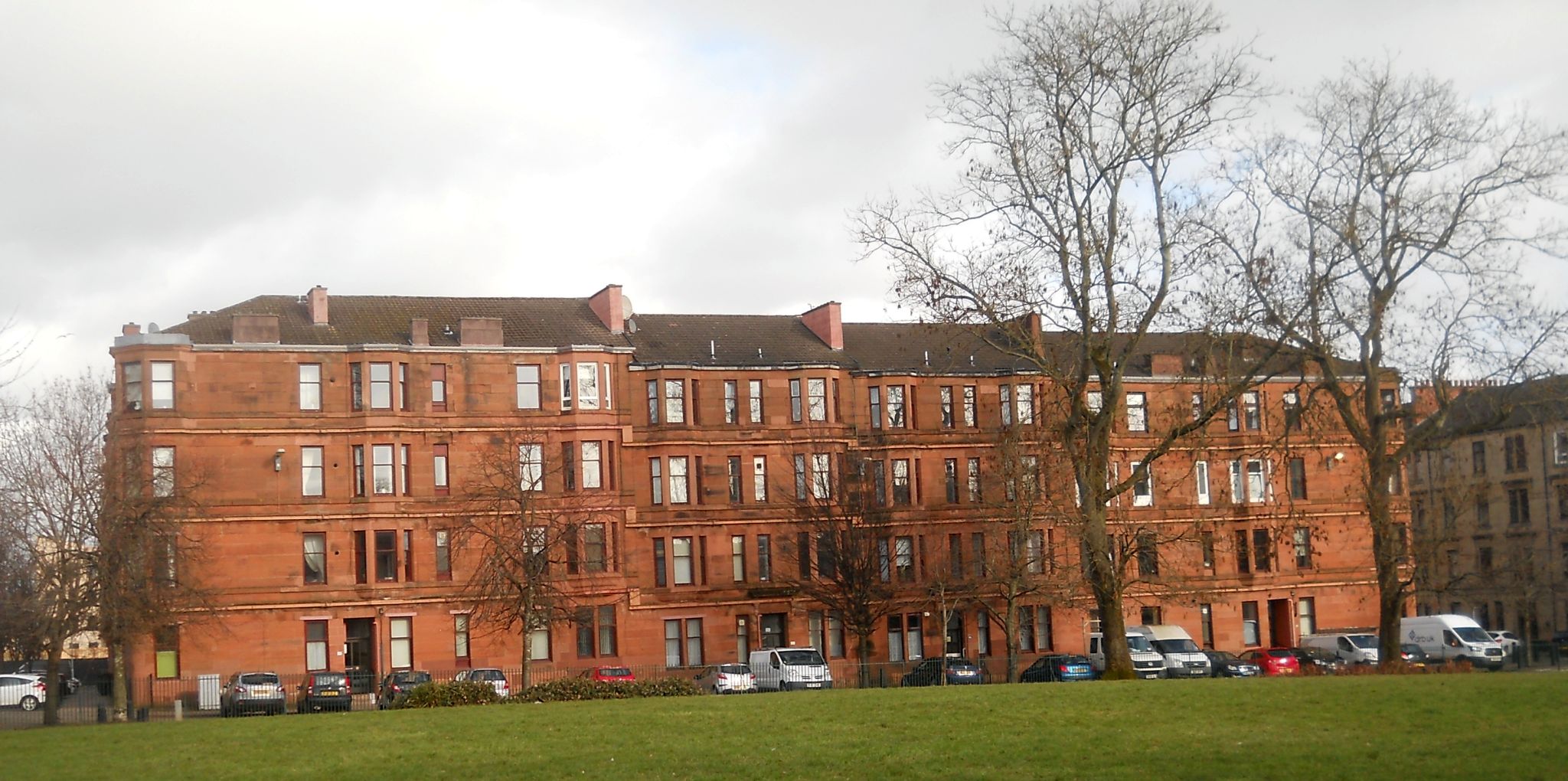 Red sandstone tenement building from Govanhill Park