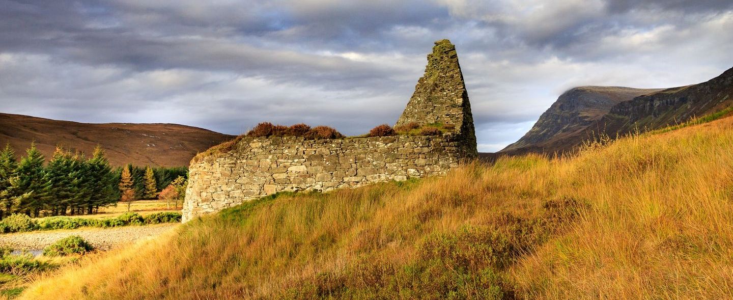 Ben Hope and Pictish Tower ( Broch ) of Dun Dornaigil at trailhead for Ben Hope in Highlands of Northern Scotland