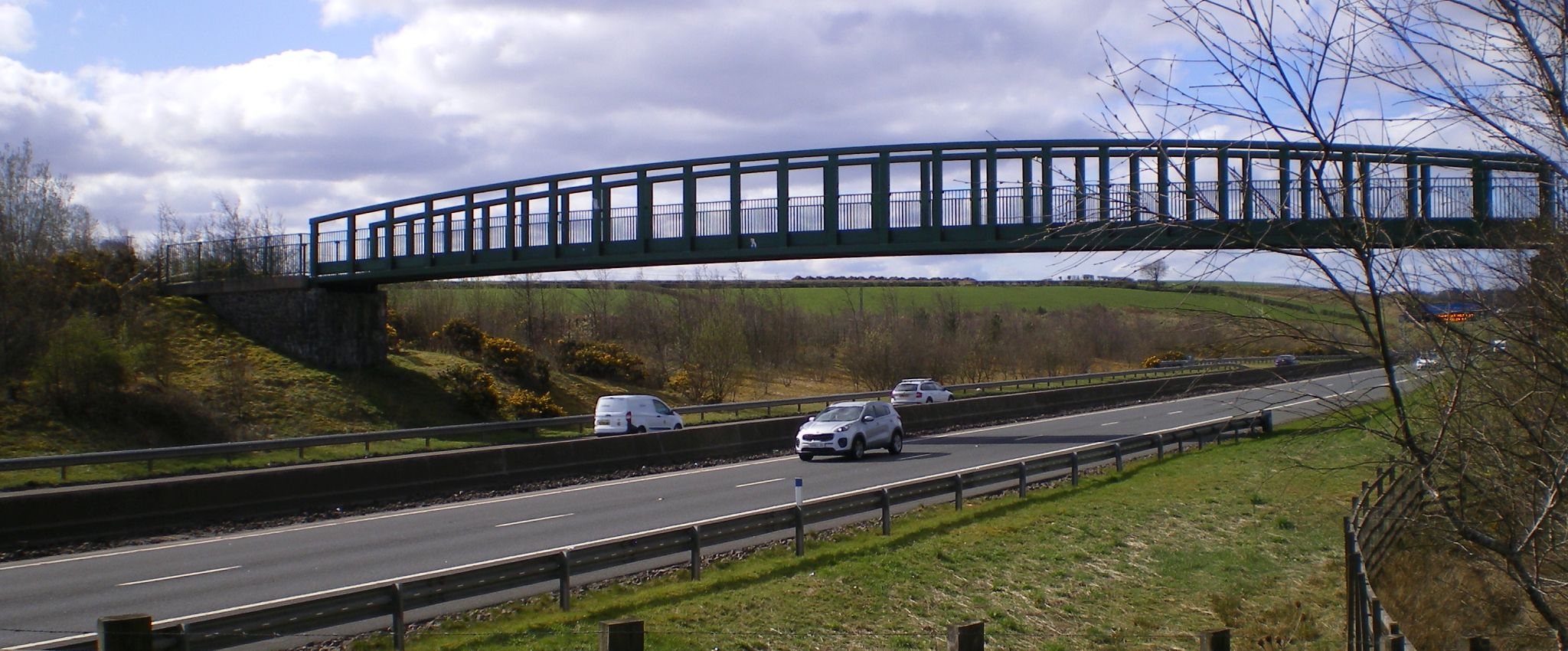 Campsie Fells and the Burnbrae Bridge carrying the Strathkelvin Railway Path over the link road to Kirkintilloch