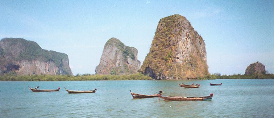 Boats and limestone cliffs at Hat Pak Meng in Trang Province in Southern Thailand