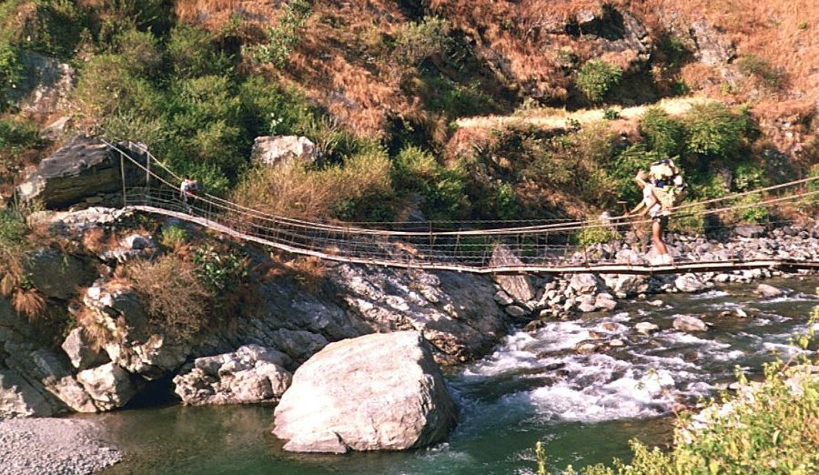 Nepalese Porter crossing Suspension Bridge across the Kabeli Khosi to Yamphudin Village